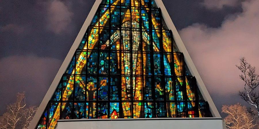 Tromso Cathedral has a striking triangular shape and a large stained-glass window. 